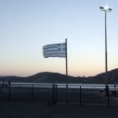 Ios's port, with the flag of Greece