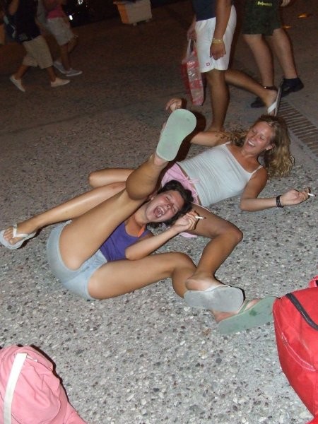 Two chicks rolling on the floor all drunk :P